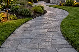 A curved paved stone path through a landscaped garden